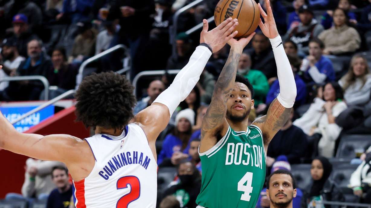Boston Celtics guard Anfernee Simons (4) takes a shot against Detroit Pistons guard Cade Cunningham (2) during the first half of an NBA basketball game Monday, Jan. 19, 2026, in Detroit.