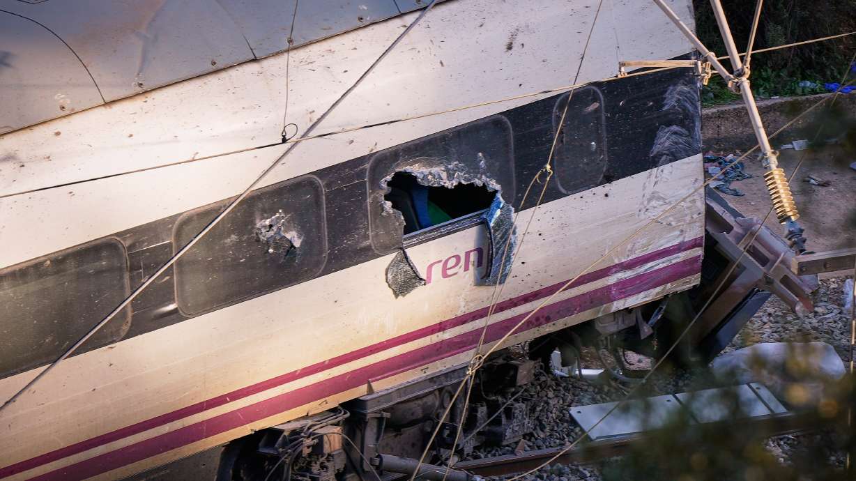Part of a wrecked train is photographed at the site of a train collision in Adamuz, southern Spain, Monday.