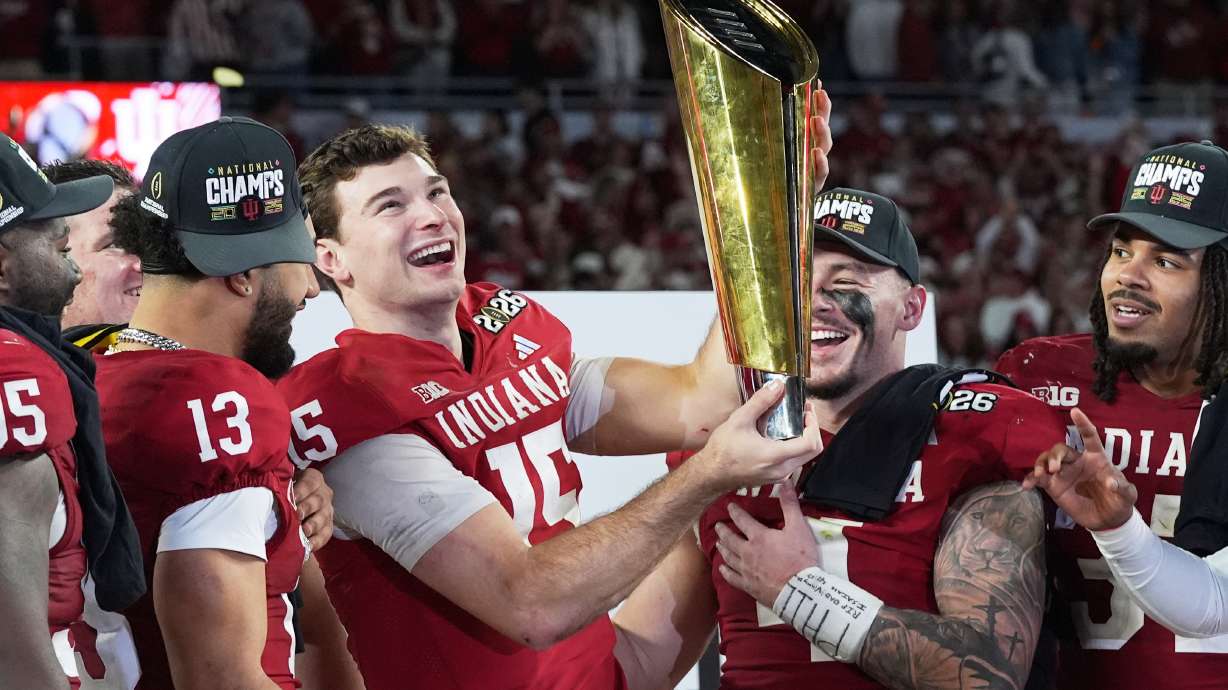 Indiana quarterback Fernando Mendoza holds the trophy after their win against Miami in the College Football Playoff national championship game, Monday, Jan. 19, 2026, in Miami Gardens, Fla.