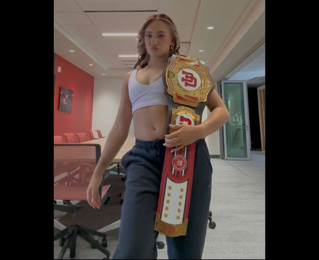 Red Rocks gymnast Makenna Smith poses with a University of Utah themed WWE belt.