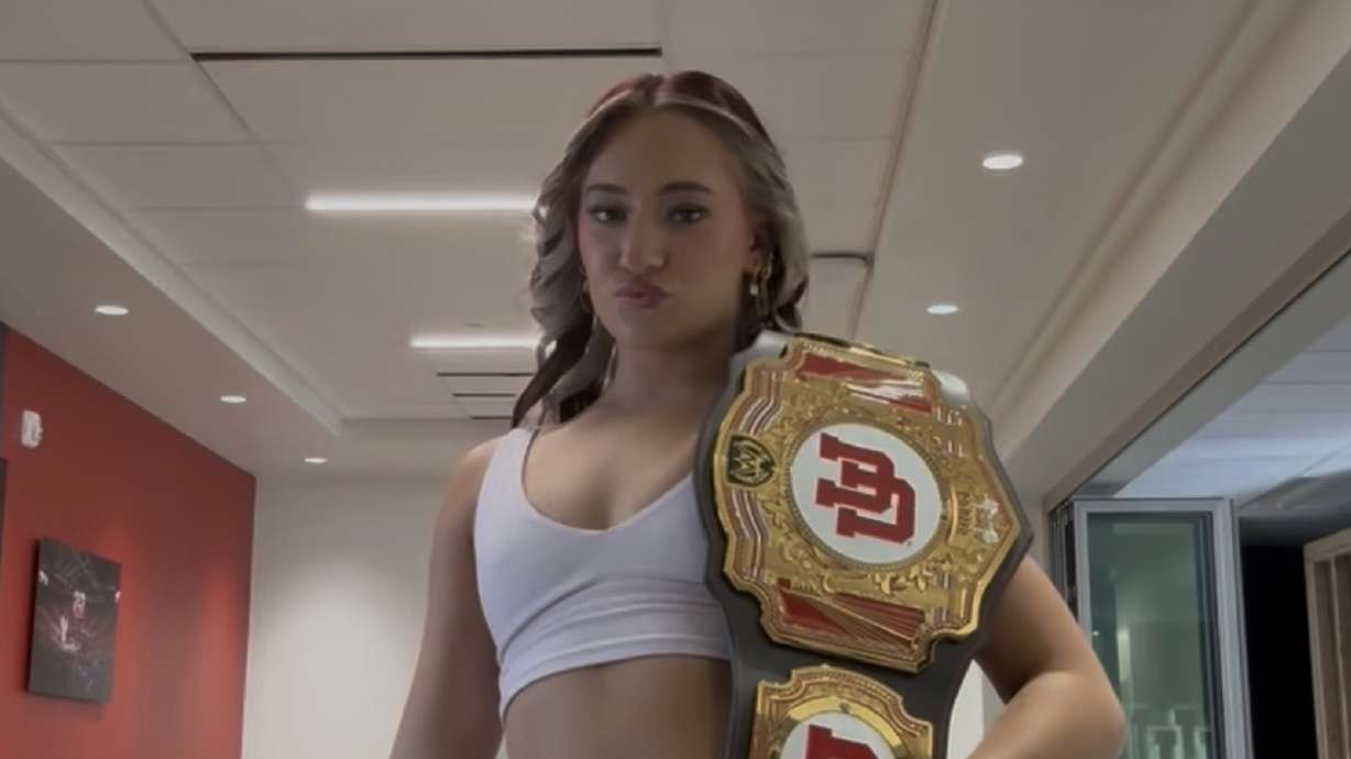 Red Rocks gymnast Makenna Smith poses with a University of Utah themed WWE belt.