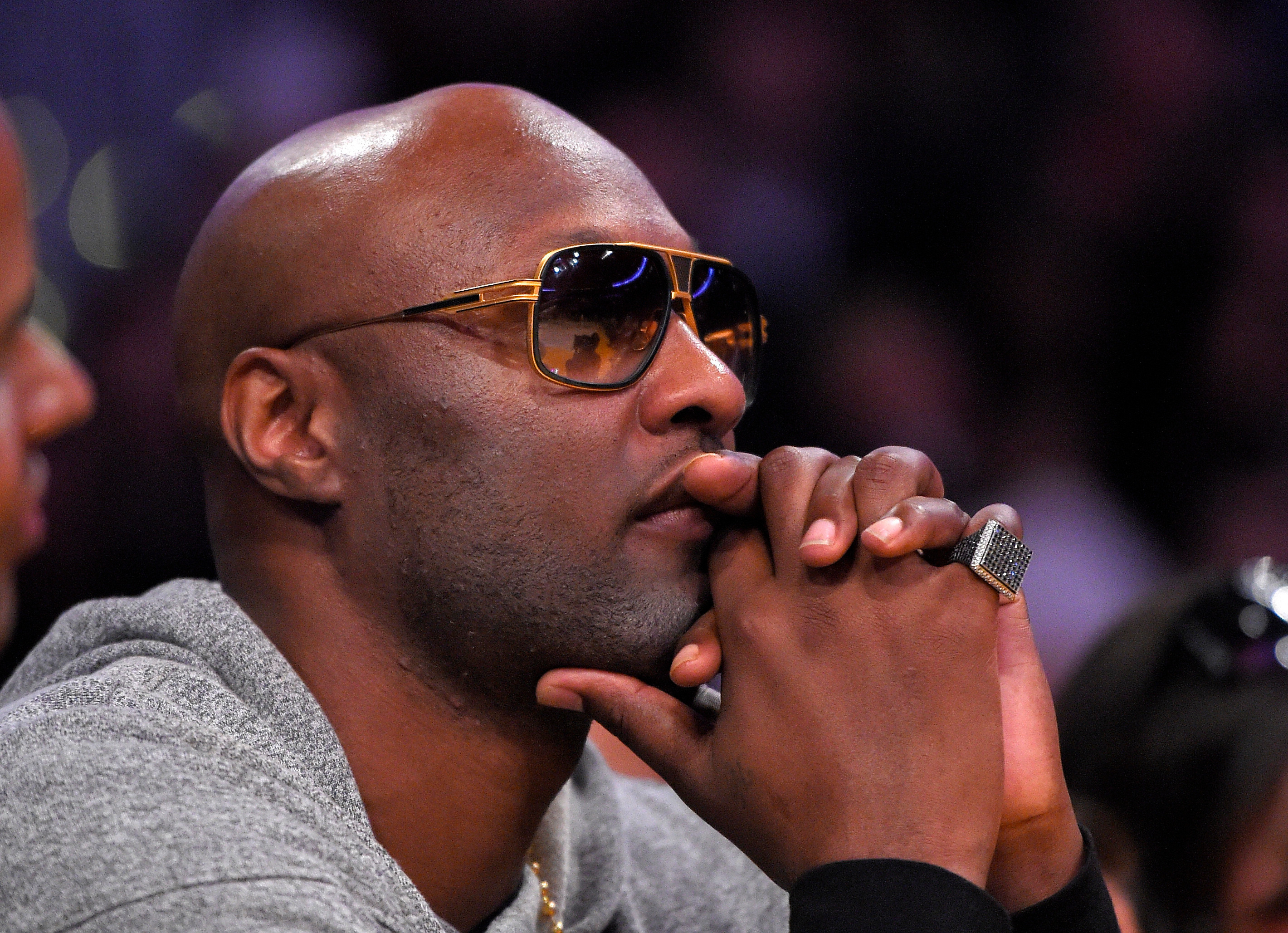 FILE - Former Los Angeles Lakers' player Lamar Odom watches during the second half of an NBA basketball game between the Lakers and the Miami Heat in Los Angeles, March 30, 2016. 