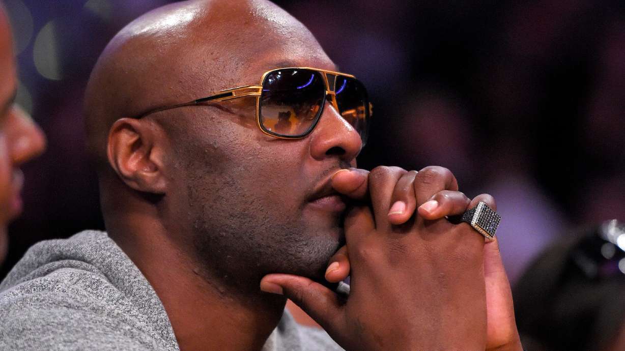 FILE - Former Los Angeles Lakers' player Lamar Odom watches during the second half of an NBA basketball game between the Lakers and the Miami Heat in Los Angeles, March 30, 2016.