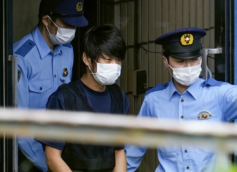 Tetsuya Yamagami, suspected of killing former Japanese Premier Shinzo Abe, is escorted by police officers at Nara-nishi police station in Nara, Japan, July 10, 2022. Yamagami was sentenced to life in prison on Wednesday.