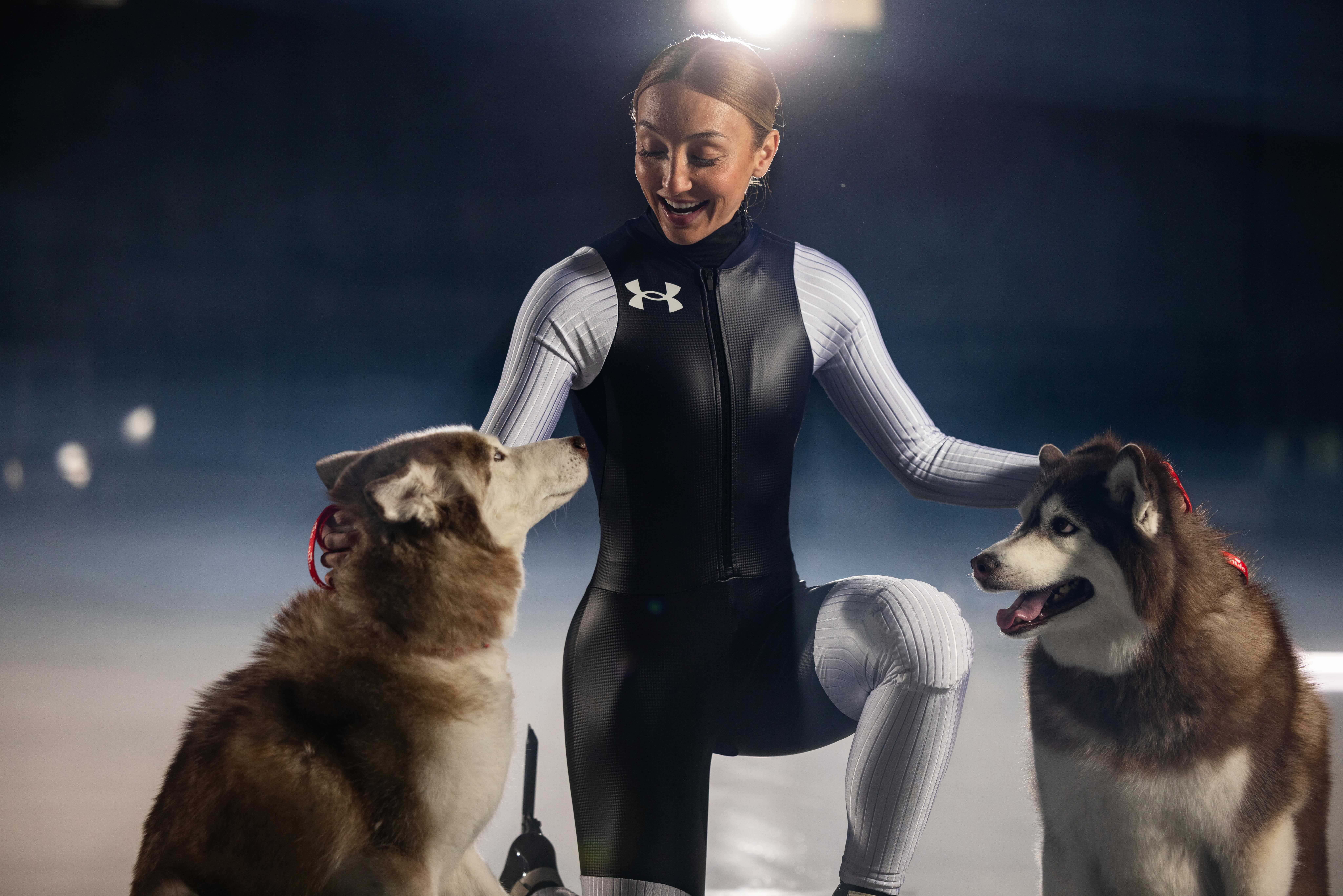 U.S. short track speed skater Kristen Santos-Griswold with her dogs Bear and Koda during a photo shoot with Nulo, the pet food supplier who is one of Santos-Griswold's sponsors en route to the Milan-Cortina Winter Olympics in February.