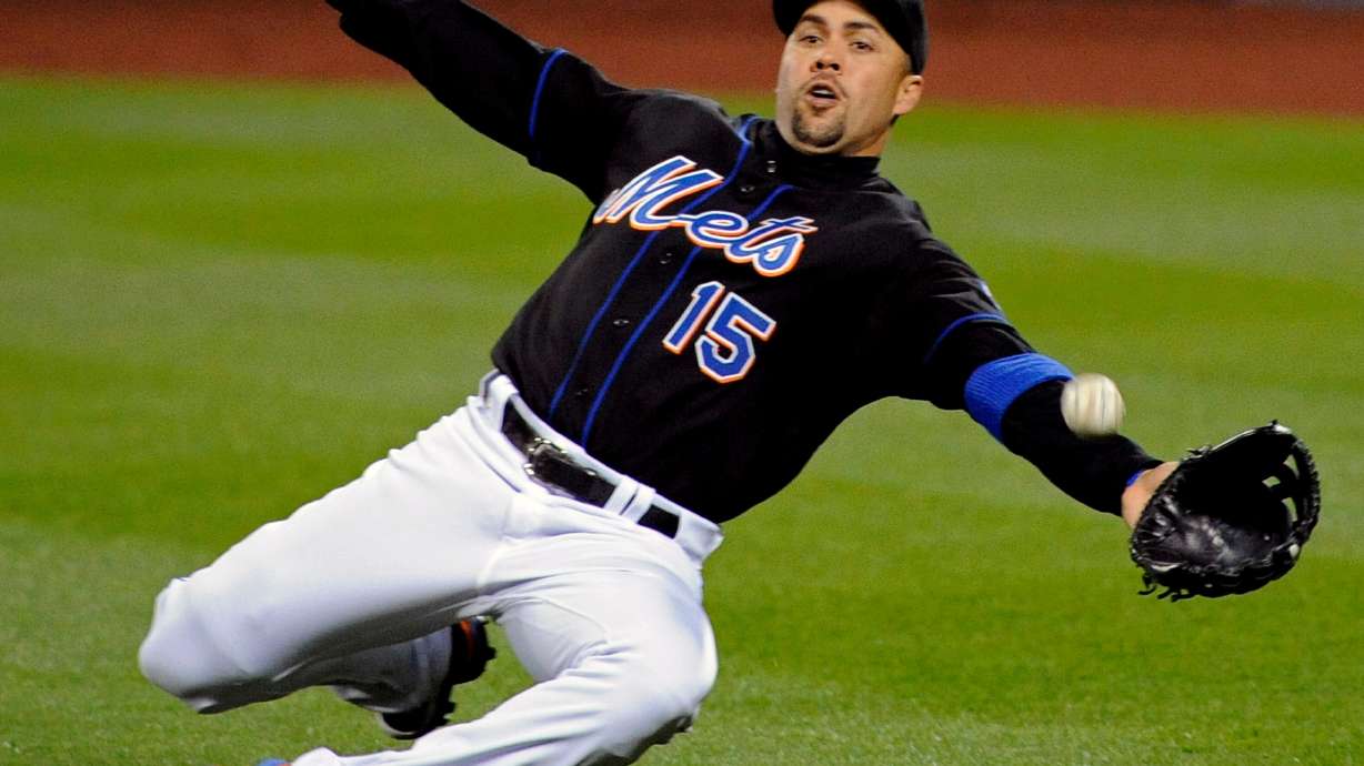 FILE - New York Mets right fielder Carlos Beltran lunges for the ball during the third inning of an MLB baseball game against the Arizona Diamondbacks, April 22, 2011 in New York.