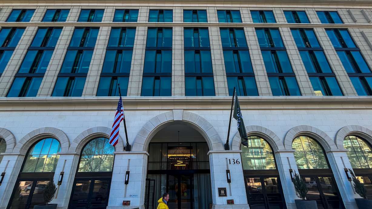 A person walks past Seraph at South Temple on Tuesday. The building, once known as South Temple Tower, reopened last month following a yearslong project to convert it from an office building into housing.