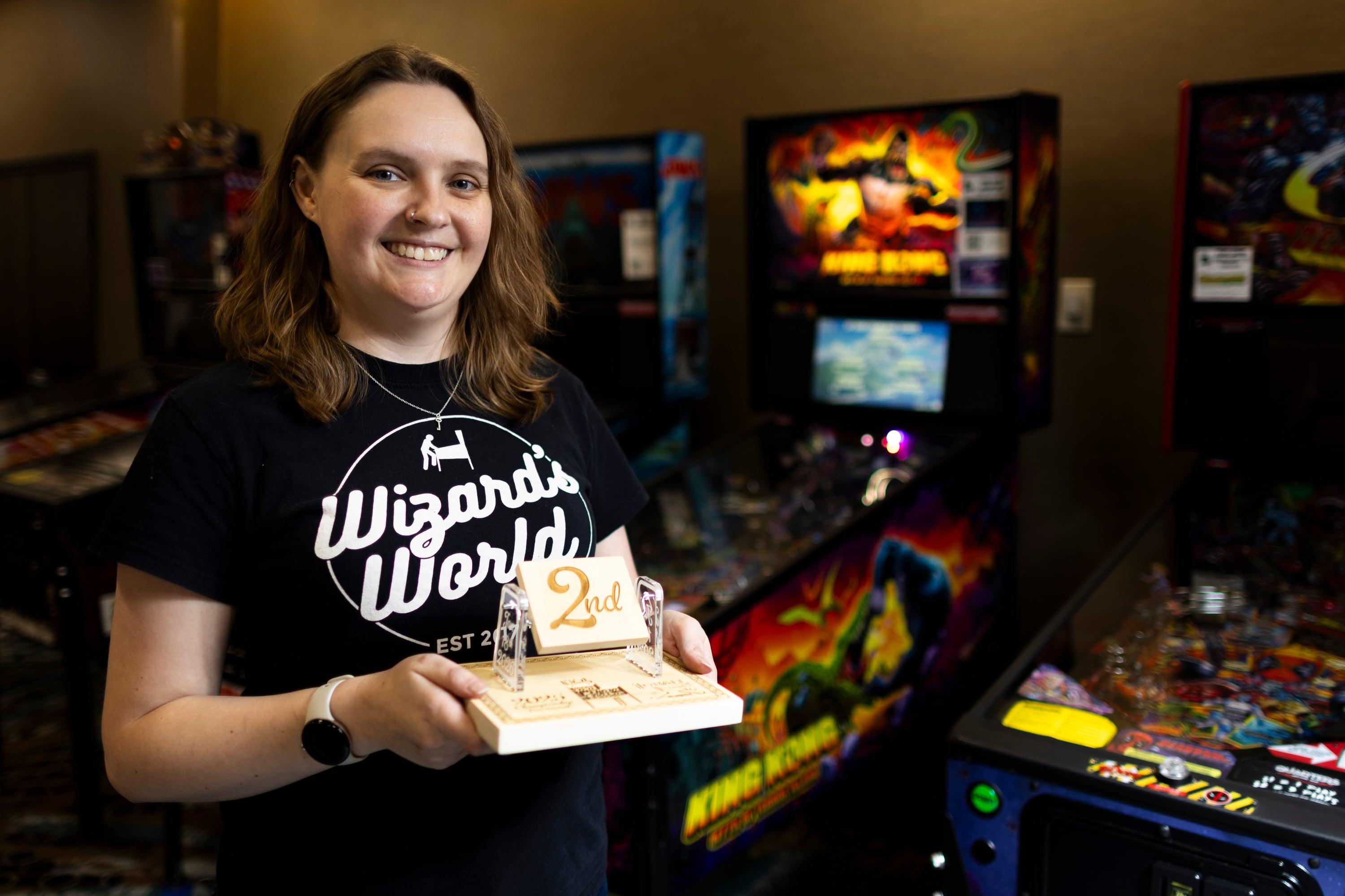 Crystal Cory poses with the second place trophy after the 2025 IFPA Women’s Pinball State Finals at the Holiday Inn in South Jordan on Sunday.