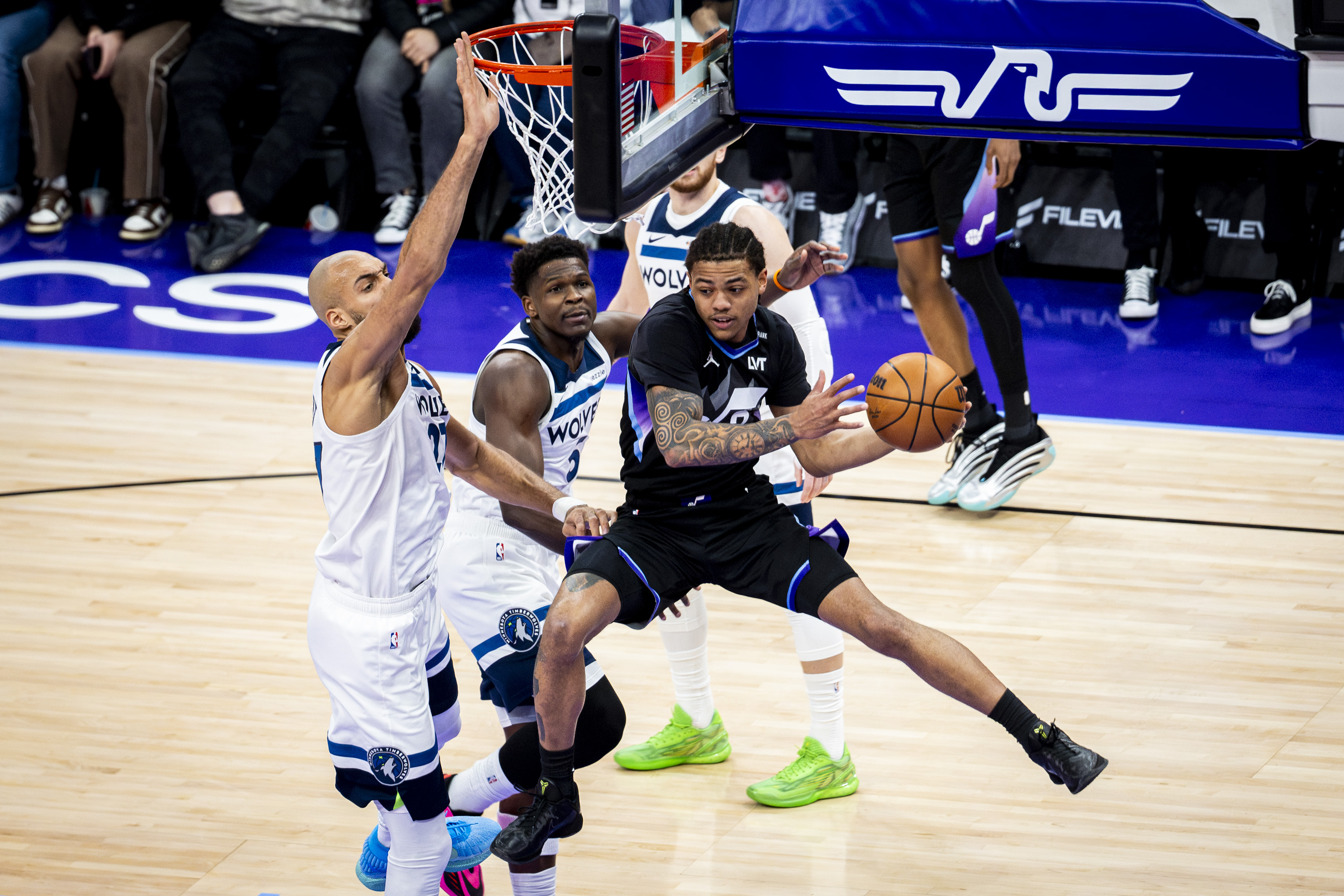 Utah Jazz guard Keyonte George (3) looks to pass the ball out mid-shot as he’s guarded by Minnesota Timberwolves center Rudy Gobert (27) and guard Anthony Edwards (5) during an NBA game held at the Delta Center in Salt Lake City on Tuesday, Jan. 20, 2026.