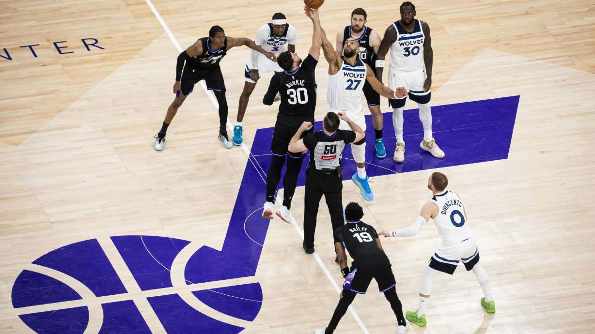 Minnesota Timberwolves center Rudy Gobert (27) and Utah Jazz center Jusuf Nurkic (30) compete for the opening tipoff during an NBA game held at the Delta Center in Salt Lake City on Tuesday, Jan. 20, 2026.