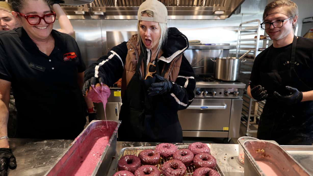 Amanda Clark, Utah Grubs content creator, makes a doughnut during the ribbon-cutting event for Sidecar Doughnuts and Coffee in Salt Lake City on Wednesday. It's one of two California chains that opened new locations in Salt Lake City over the past week.