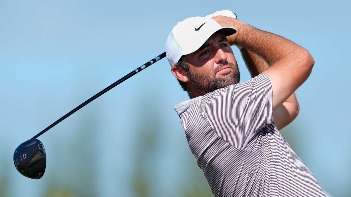 FILE - Scottie Scheffler, of the United States, watches his tee-off at the fourth hole during the final round of the Hero World Challenge PGA Tour at the Albany Golf Club in New Providence, Bahamas, Dec. 7, 2025.