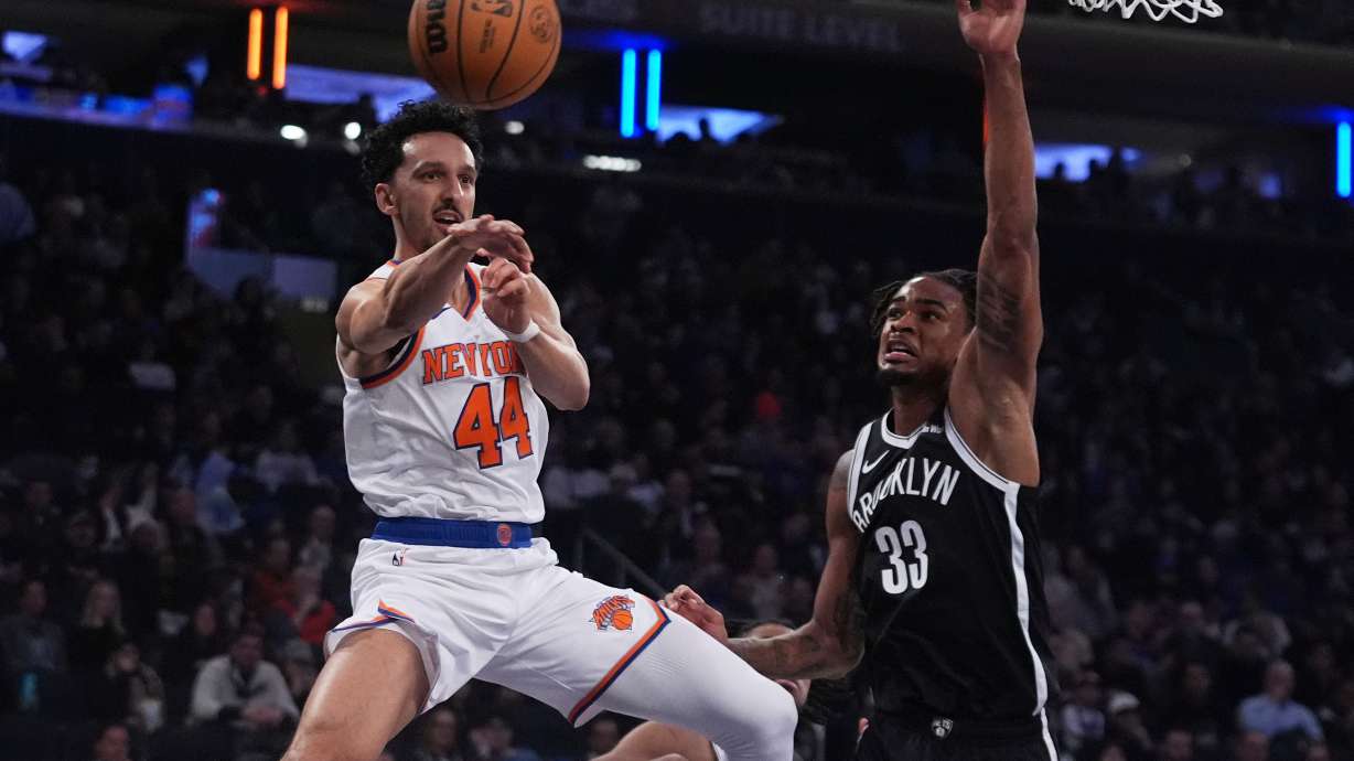 New York Knicks' Landry Shamet (44) passes away from Brooklyn Nets' Nic Claxton (33) during the first half of an NBA basketball game Wednesday, Jan. 21, 2026, in New York.