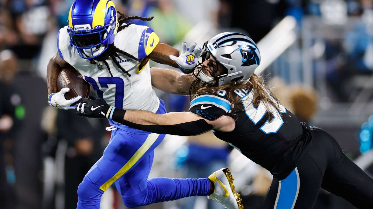 Los Angeles Rams wide receiver Davante Adams (17) is tackled by Carolina Panthers linebacker Christian Rozeboom during the second half of an NFL wild-card playoff football game, Saturday, Jan. 10, 2026, in Charlotte, N.C.