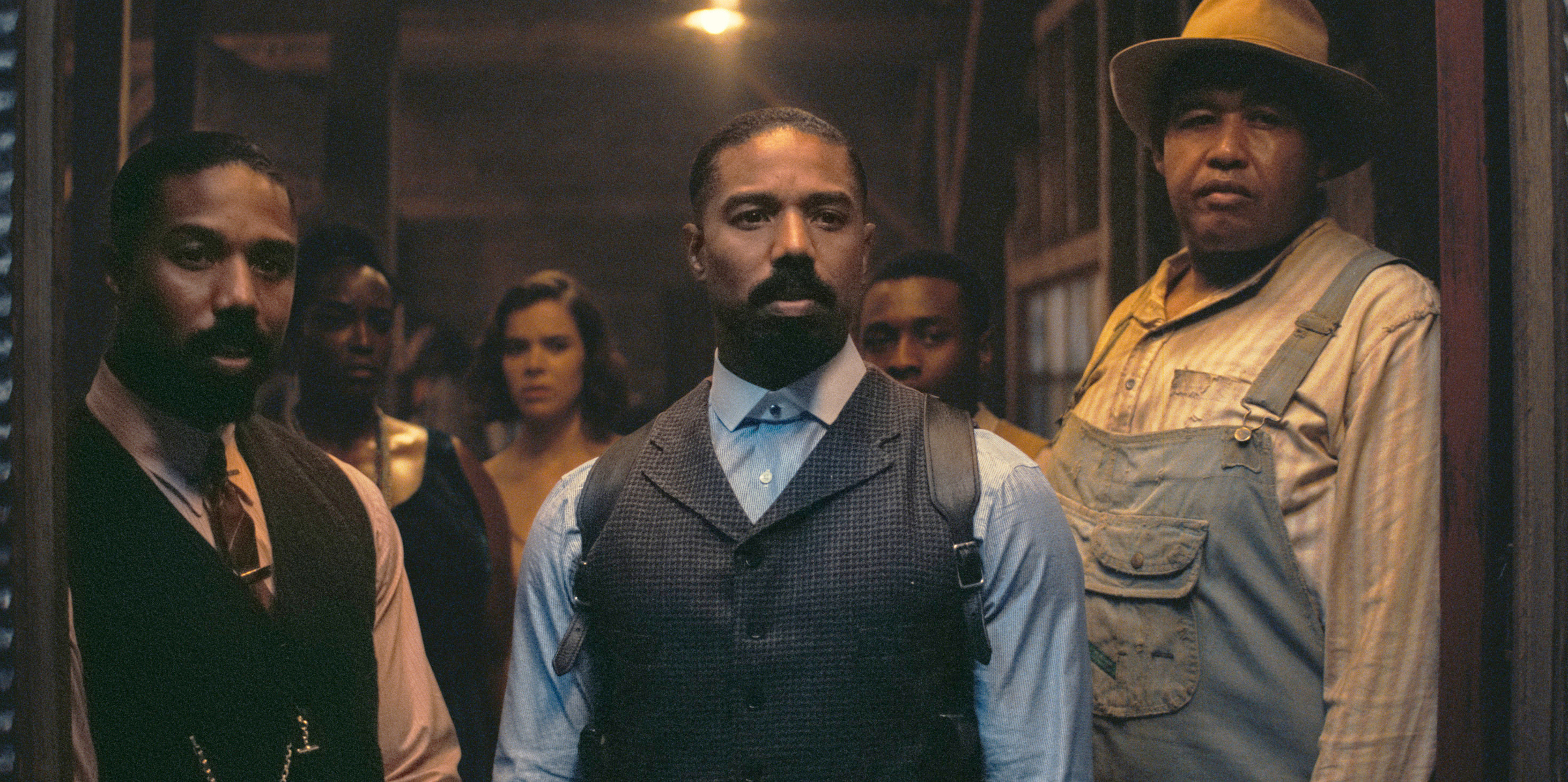 This image released by Warner Bros Pictures shows Michael B. Jordan, foreground from left, and Omar Benson Miller in a scene from "Sinners." 