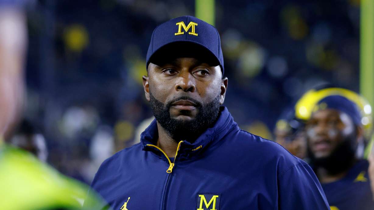 FILE - Michigan coach Sherrone Moore walks off the field following an NCAA football game Aug. 30, 2025, in Ann Arbor, Mich.