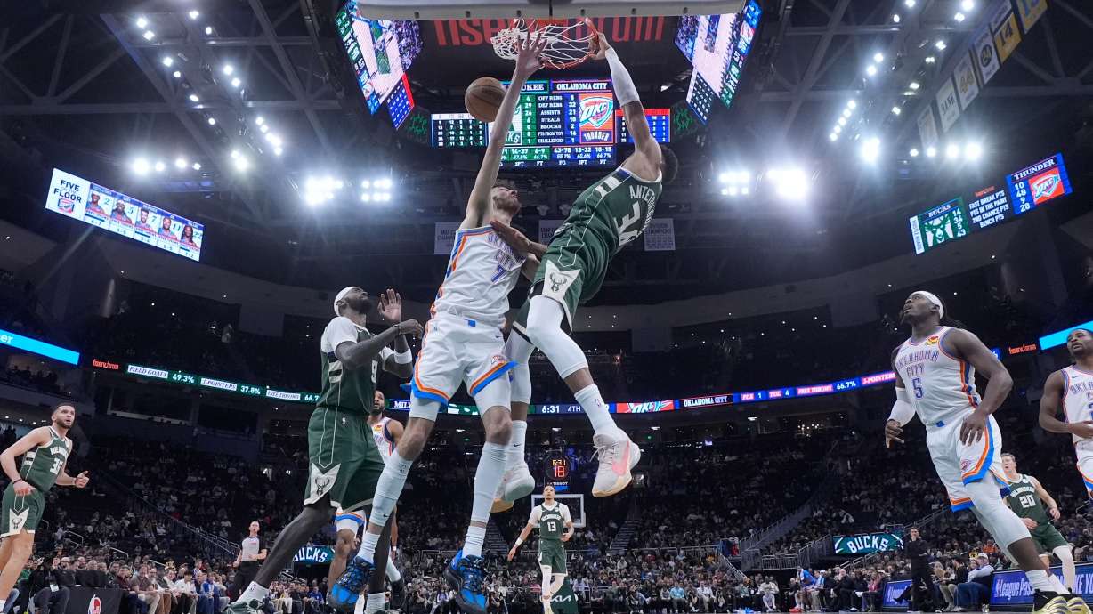 Milwaukee Bucks' Giannis Antetokounmpo dunks over Oklahoma City Thunder's Chet Holmgren during the second half of an NBA basketball game Wednesday, Jan. 21, 2026, in Milwaukee.