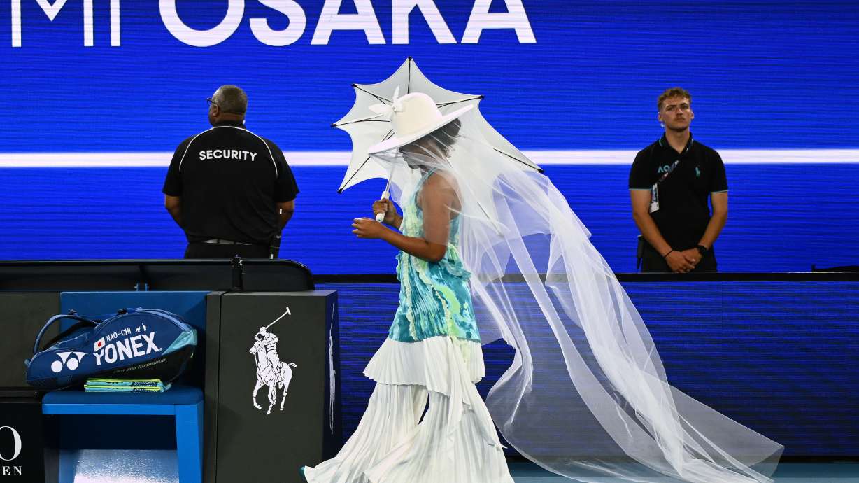 Naomi Osaka of Japan walks onto Rod Laver Arena for her first round match against Antonia Ruzic of Croatia at the Australian Open tennis championship in Melbourne, Australia, Tuesday, Jan. 20, 2026.