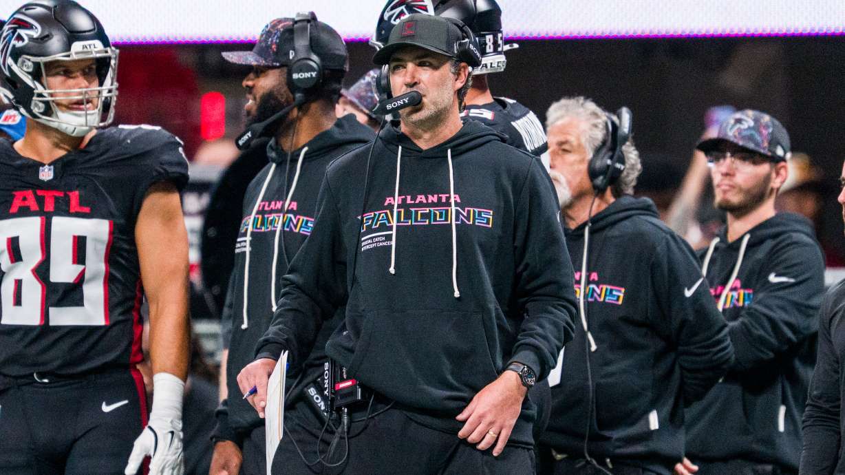 FILE - Atlanta Falcons offensive coordinator Zac Robinson works during the first half of an NFL football game against the Washington Commanders, Sunday, Sep. 28, 2025, in Atlanta.