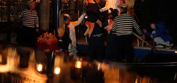 Olympic flame glides on traditional Venetian boats down the Grand Canal