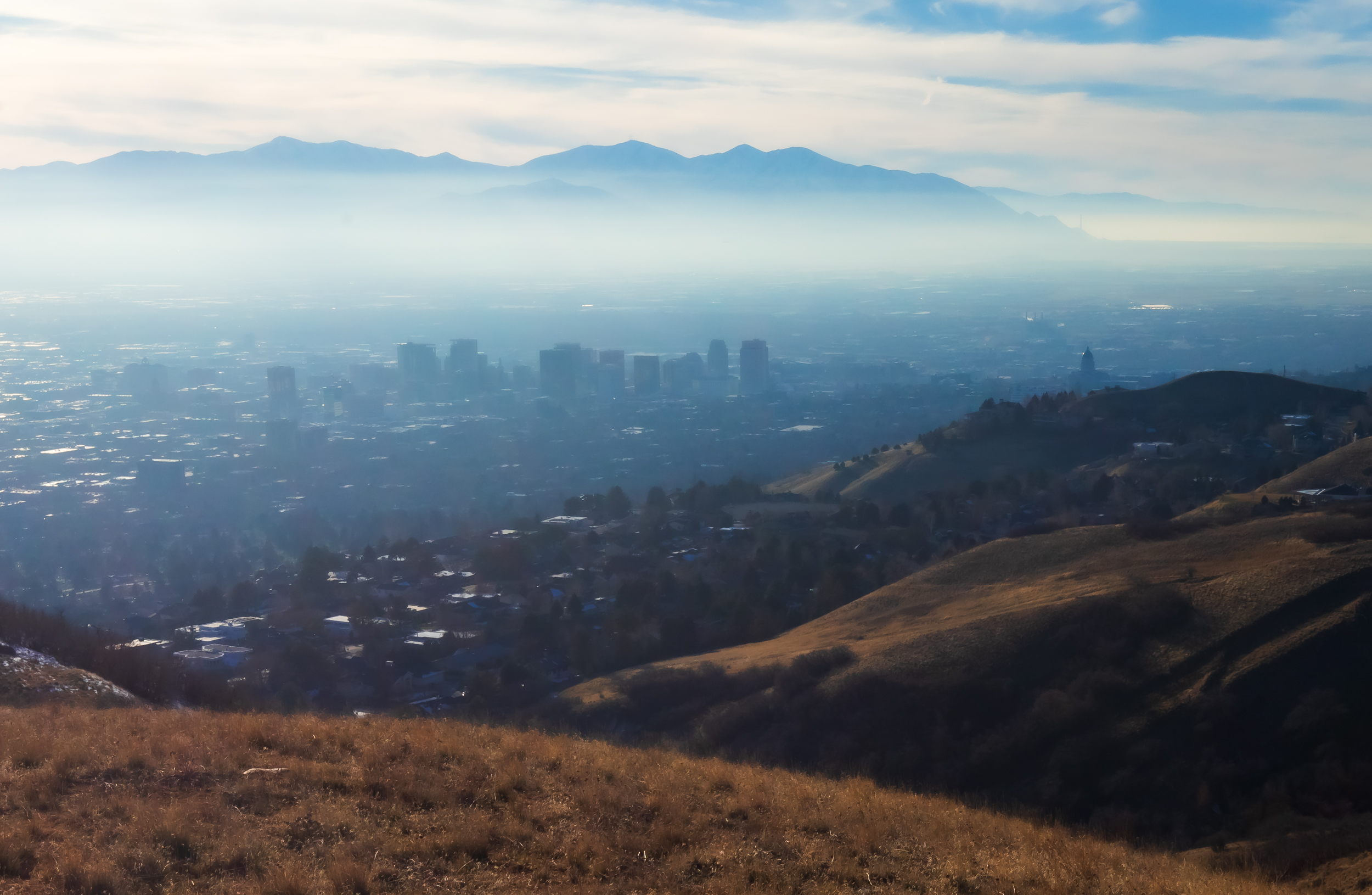 Inversion haze over Salt Lake City on Sunday. A dry cold front is forecast to break up the inversion on Friday, while another system is forecast to produce snow in other parts of the state.
