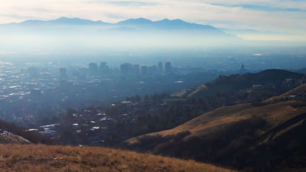 Inversion haze over Salt Lake City on Sunday. A dry cold front is forecast to break up the inversion on Friday, while another system is forecast to produce snow in other parts of the state.