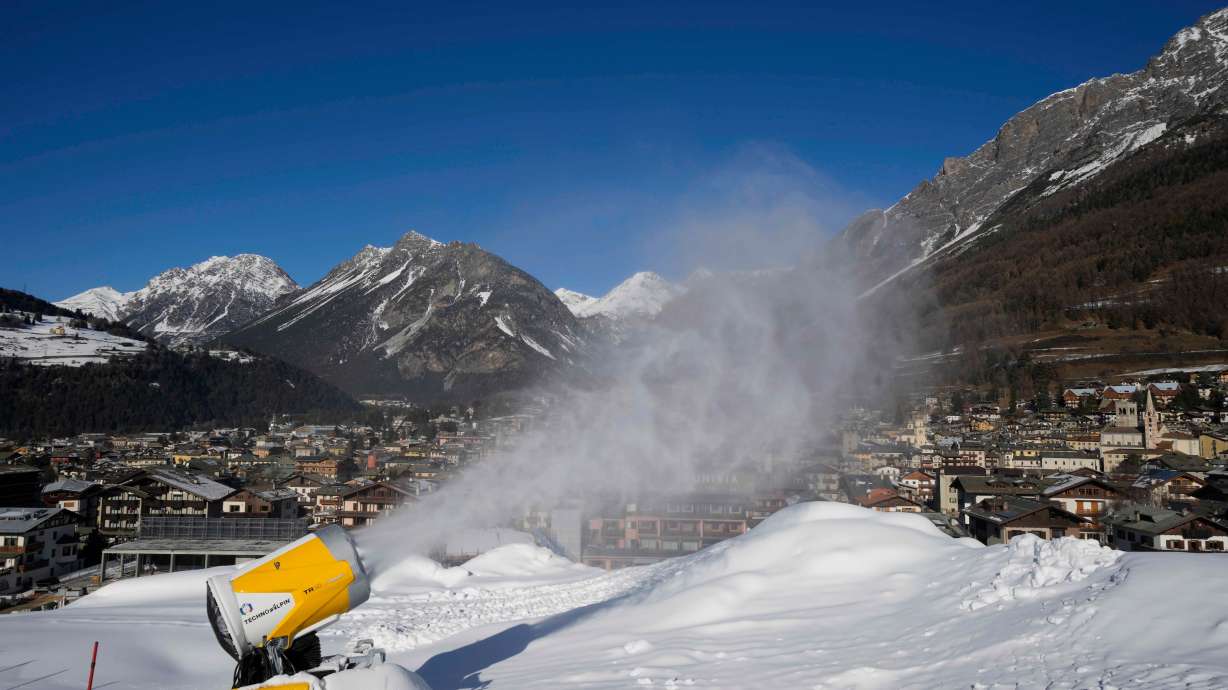 FILE - A snow gun sprays artificial snow at the Stelvio Ski Center, venue for the alpine ski and ski mountaineering disciplines at the 2026 Milan Cortina Winter Olympics, in Bormio, Italy, Jan. 16, 2025.