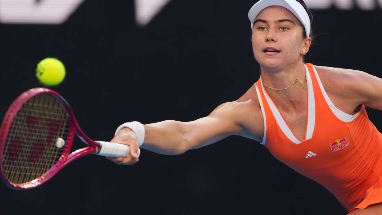 Iva Jovic of the U.S. plays a forehand return to Jasmine Paolini of Italy during their third round match at the Australian Open tennis championship in Melbourne, Australia, Friday, Jan. 23, 2026.