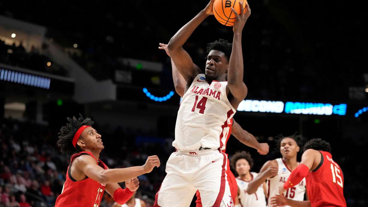 FILE - Alabama center Charles Bediako (14) pulls down a rebound while guarded by Maryland guard Ian Martinez, left, during the second half of a second-round college basketball game in the men's NCAA Tournament in Birmingham, Ala., March 18, 2023.