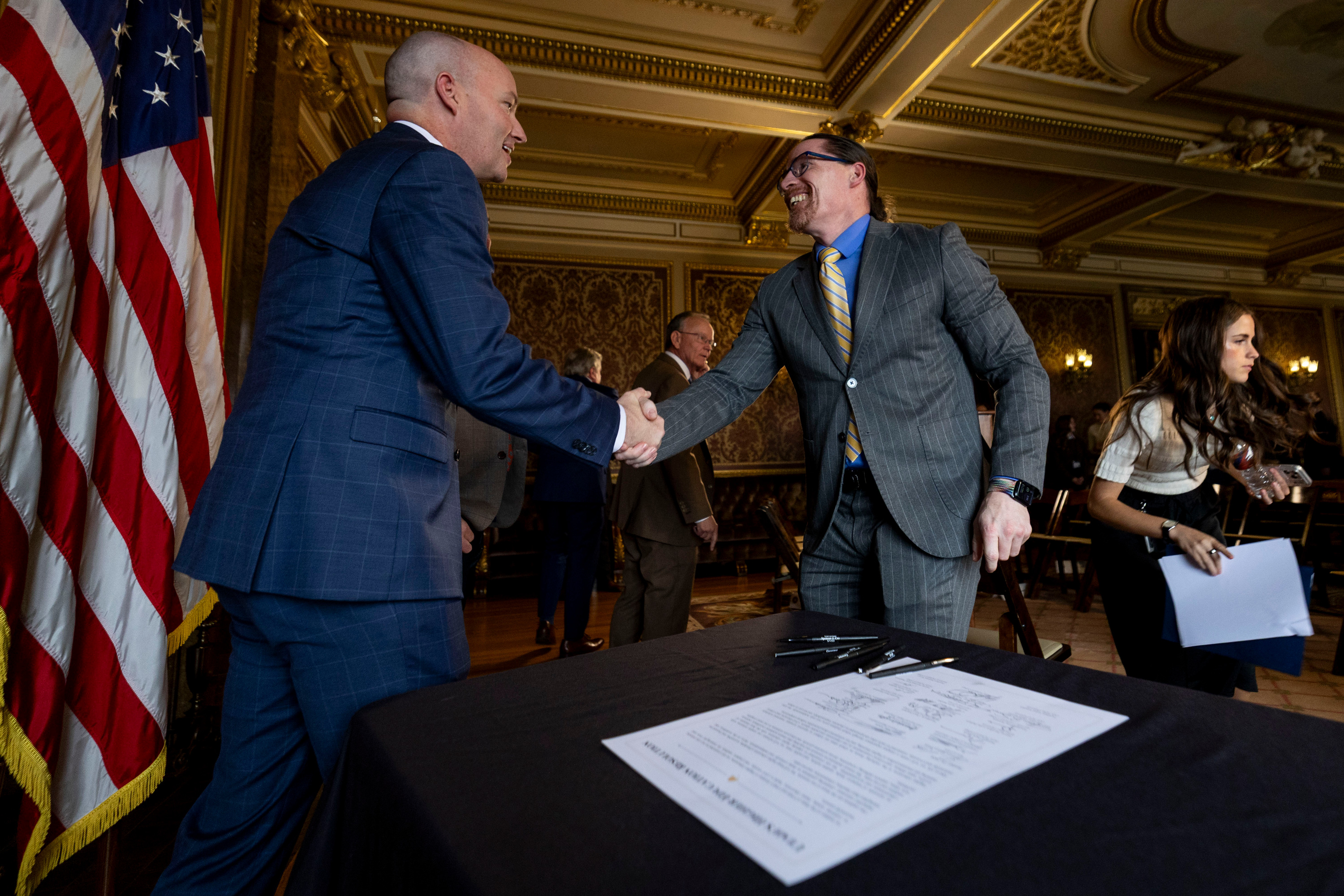 Gov. Spencer Cox shakes hands with Salt Lake Community College President Greg Peterson during a press conference for the signing of Utah’s Higher Education Resolution in the Gold Room of the Capitol in Salt Lake City on Friday.
