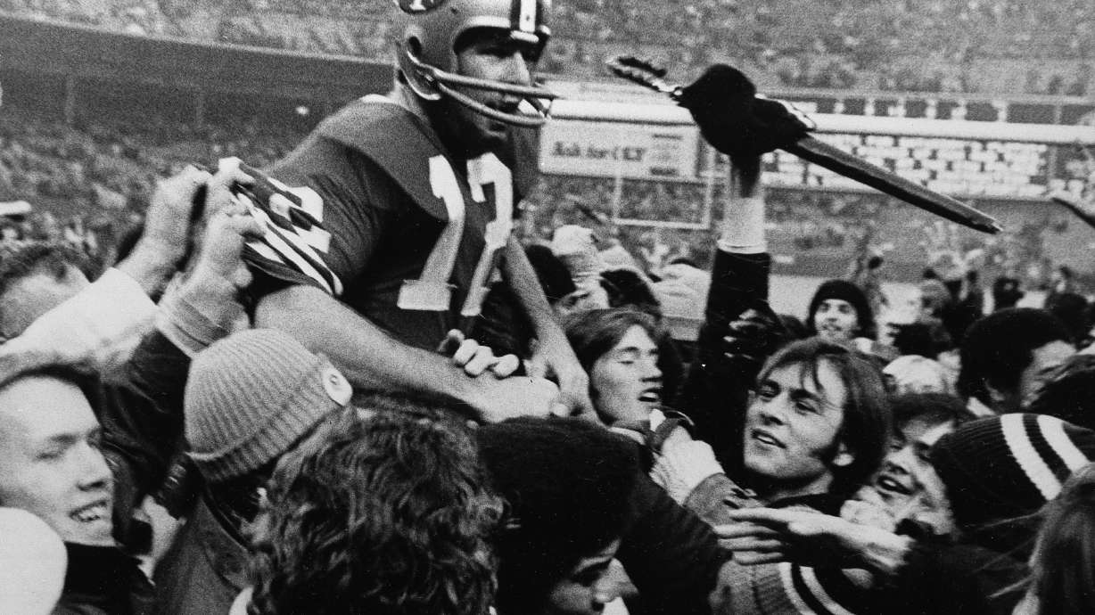 FILE - John Brodie, veteran San Francisco 49ers quarterback, gets a free ride on the shoulders of an admiring crowd following their win over the Minnesota Vikings that gave the 49ers the Western Division championship in San Francisco, Dec. 16, 1972.