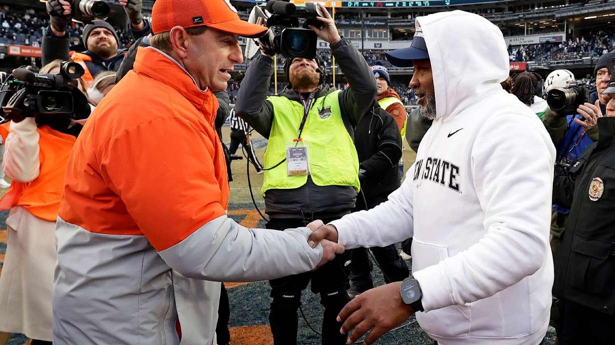 Penn State interim head coach Terry Smith, right, shakes ands with Clemson head coach Dabo Swinney after the Pinstripe Bowl NCAA college football game at Yankee Stadium, Saturday, Dec. 27, 2025, in New York.