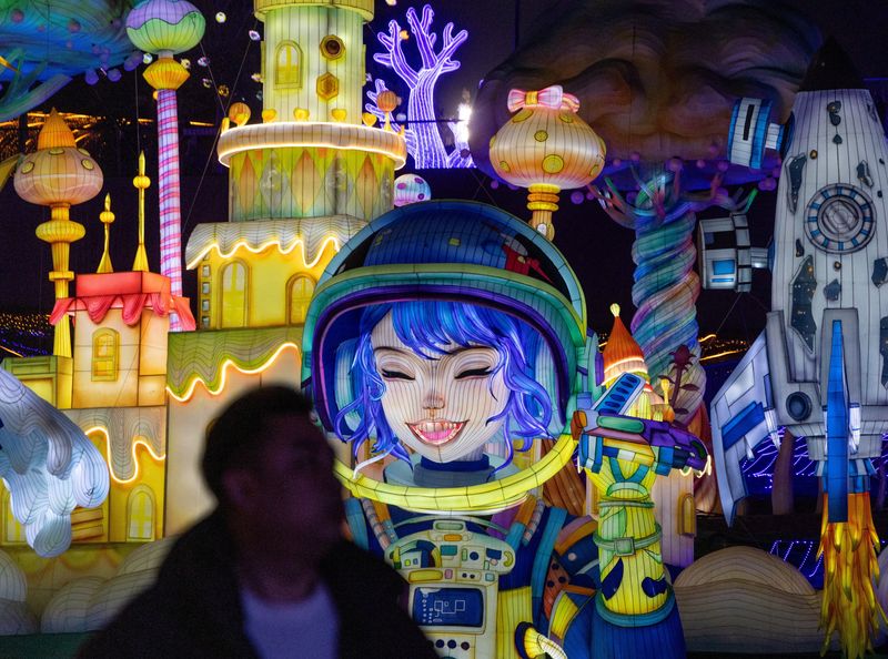 A man looks on next to light installations at the 32nd Zigong International Lantern Festival ahead of the Chinese Lunar New Year, which will welcome the Year of the Horse, in Zigong, Sichuan province, China, Friday. 