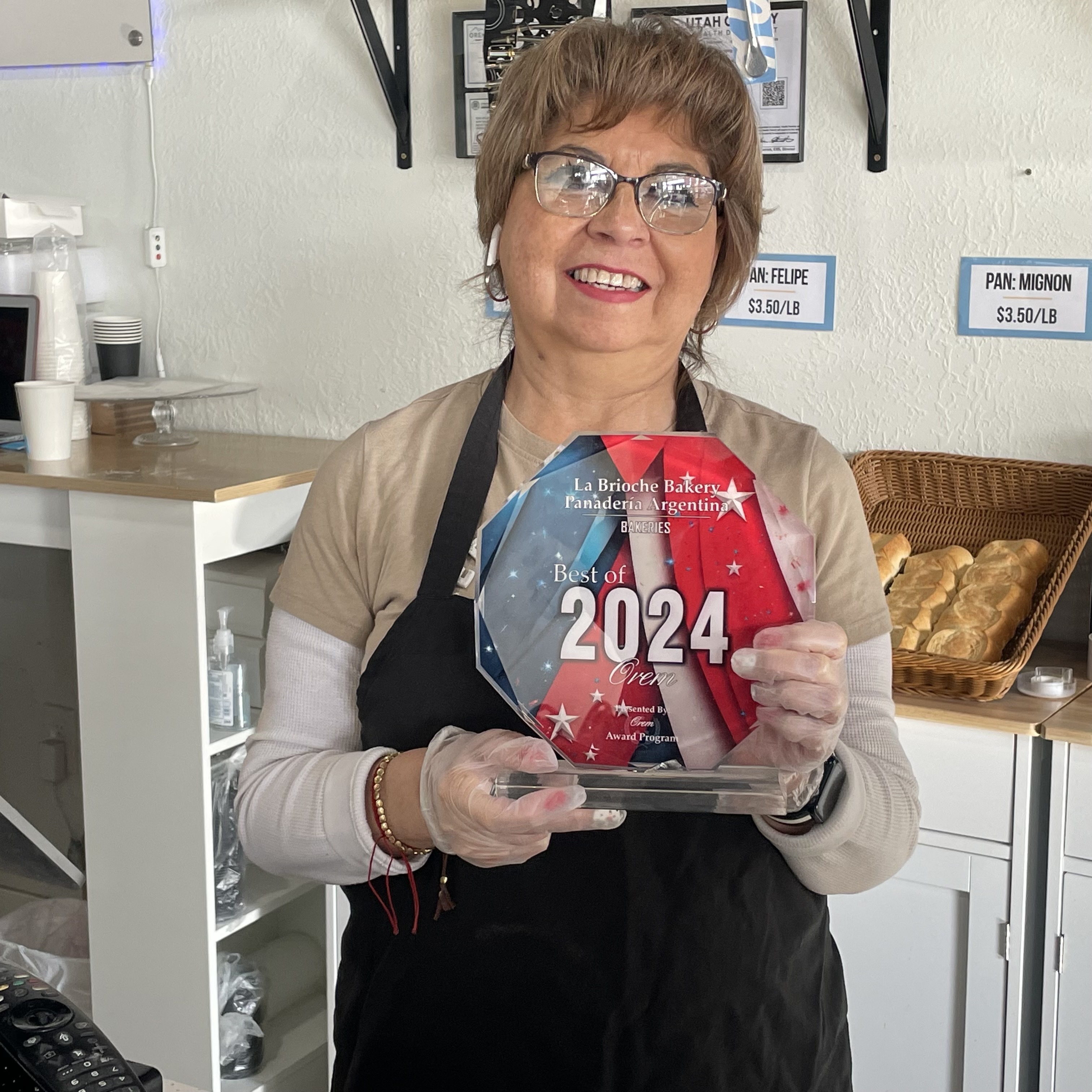 Leticia Silva, owner of  La Brioche Argentine Bakery holds a 2024 "Best of Orem" plaque on Friday. The family-owned Orem business will close Feb. 1 due to financial hurdles that have made sustaining the bakery too challenging to continue.