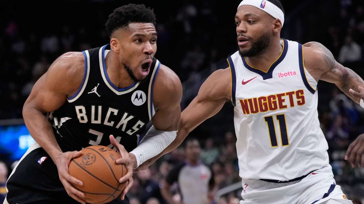 Milwaukee Bucks' Giannis Antetokounmpo tries to drive past Denver Nuggets' Bruce Brown during the second half of an NBA basketball game Friday, Jan. 23, 2026, in Milwaukee.