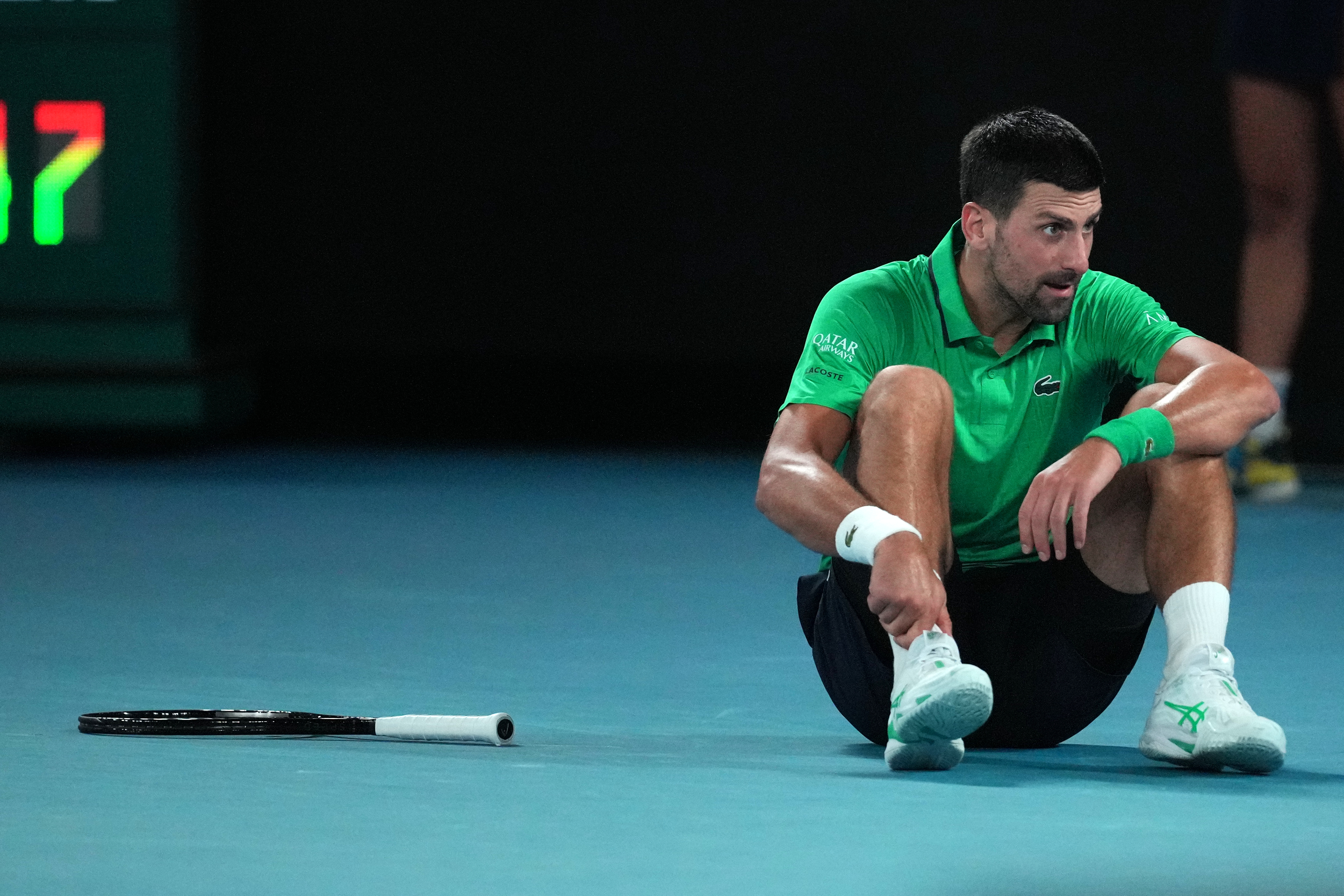Novak Djokovic of Serbia reacts after a fall during his third round match against Botic van de Zandschulp of the Netherlands at the Australian Open tennis championship in Melbourne, Australia, Saturday, Jan. 24, 2026. 