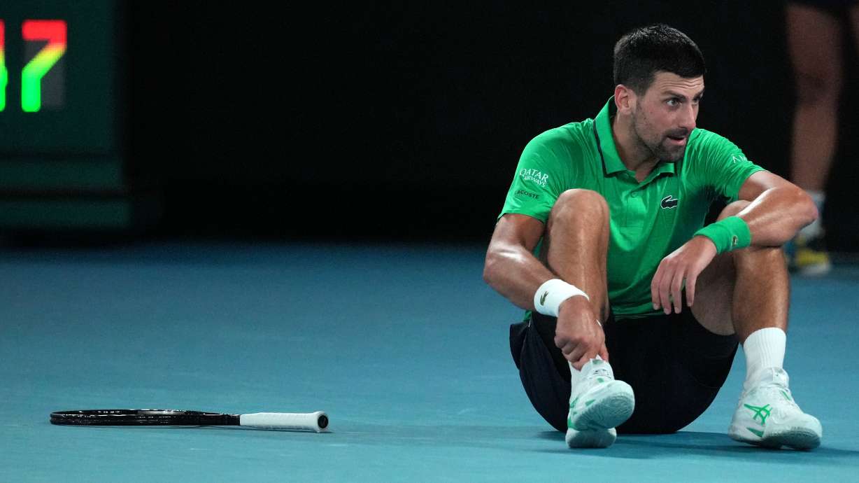 Novak Djokovic of Serbia reacts after a fall during his third round match against Botic van de Zandschulp of the Netherlands at the Australian Open tennis championship in Melbourne, Australia, Saturday, Jan. 24, 2026.