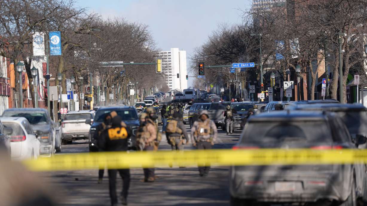 Federal agents stand near the site of a shooting Saturday in Minneapolis.
