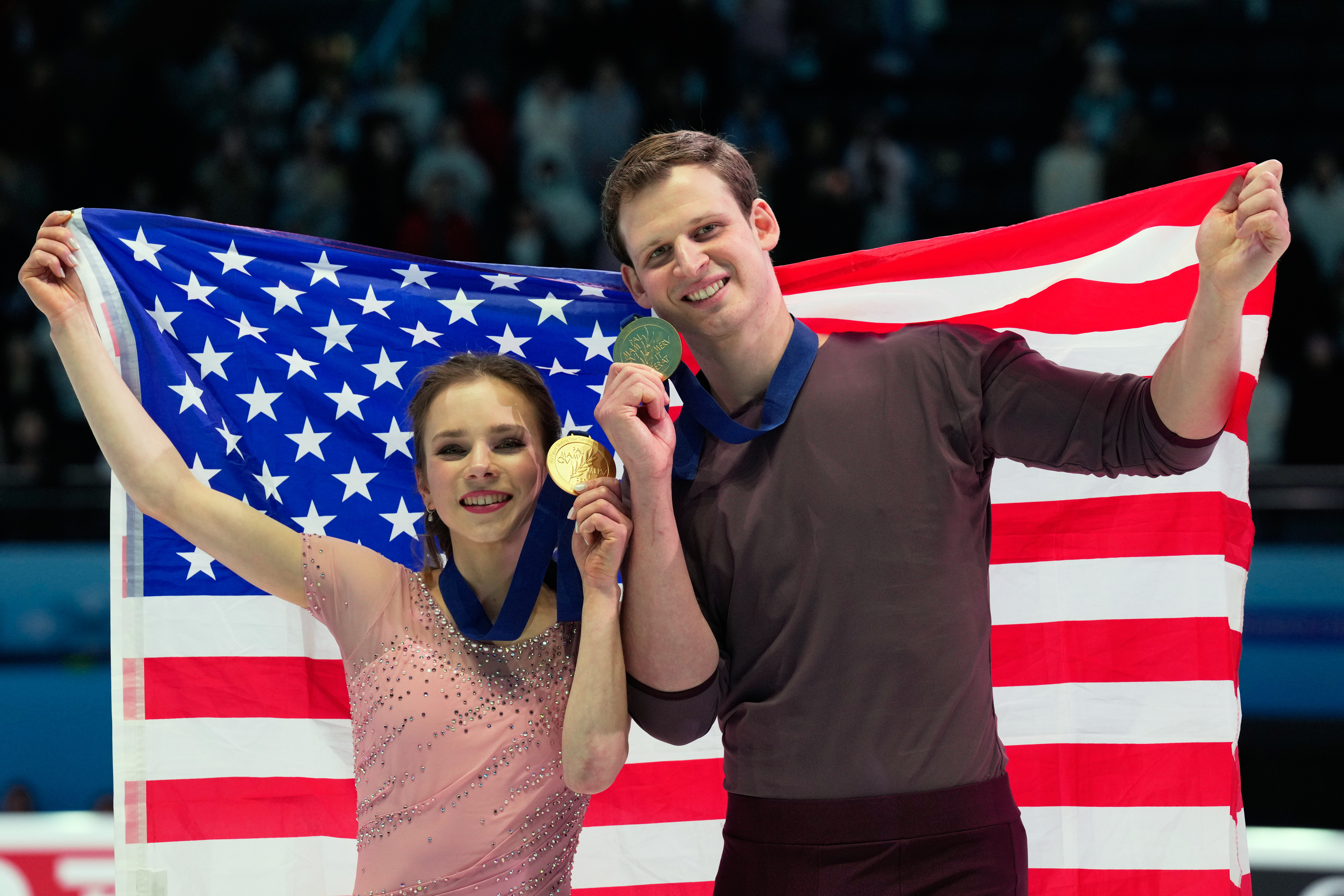 Gold medalists Alisa Efimova and Misha Mitrofanov of the United States celebrate with their national flag and medals after the Pairs Free Skating of the ISU Four Continents Figure Skating Championships in Beijing, China, Saturday, Jan. 24, 2026. 