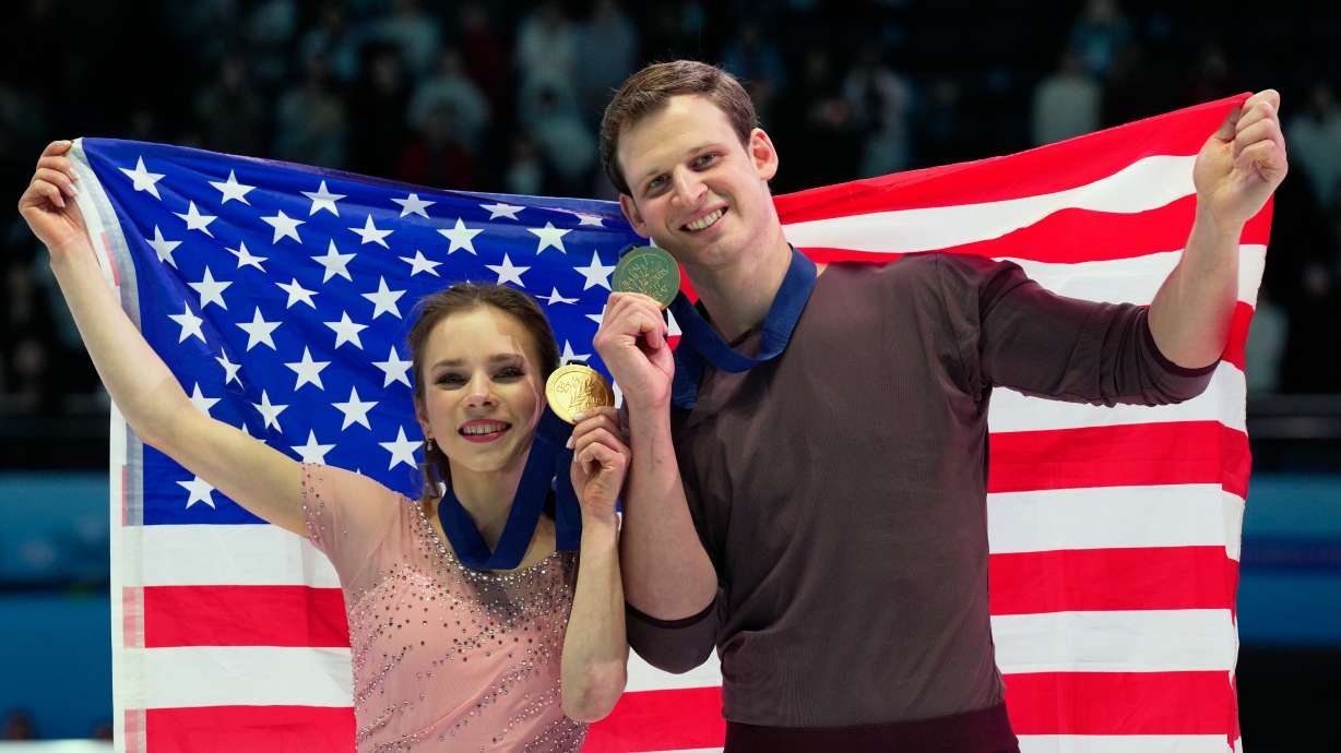 Gold medalists Alisa Efimova and Misha Mitrofanov of the United States celebrate with their national flag and medals after the Pairs Free Skating of the ISU Four Continents Figure Skating Championships in Beijing, China, Saturday, Jan. 24, 2026.
