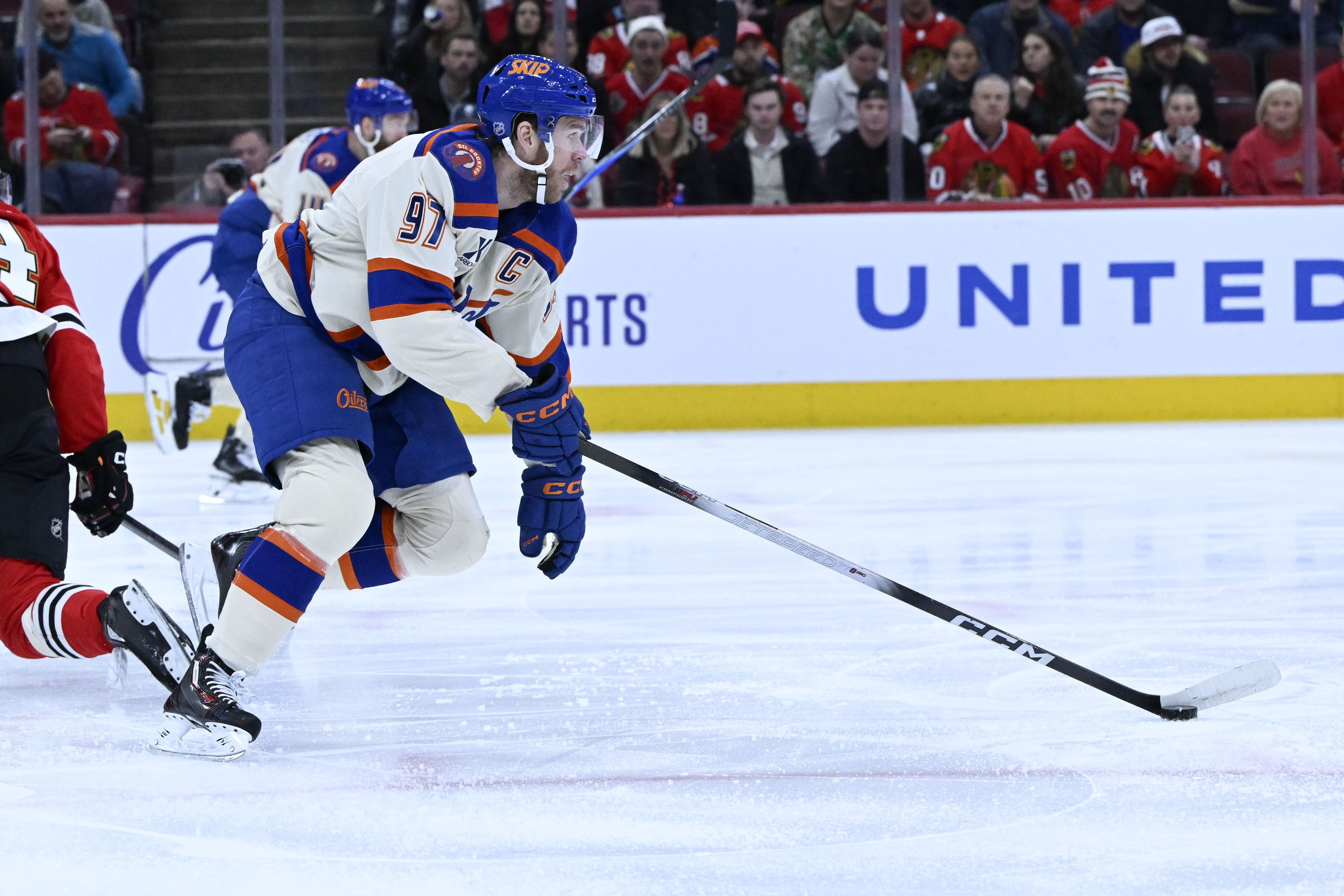 Edmonton Oilers center Connor McDavid (97) moves the puck against the Chicago Blackhawks during the first period of an NHL hockey game, Monday, Jan. 12, 2026, in Chicago. 
