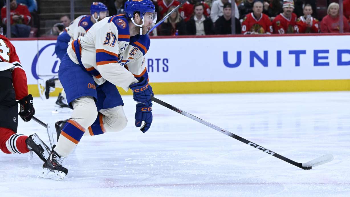 Edmonton Oilers center Connor McDavid (97) moves the puck against the Chicago Blackhawks during the first period of an NHL hockey game, Monday, Jan. 12, 2026, in Chicago.