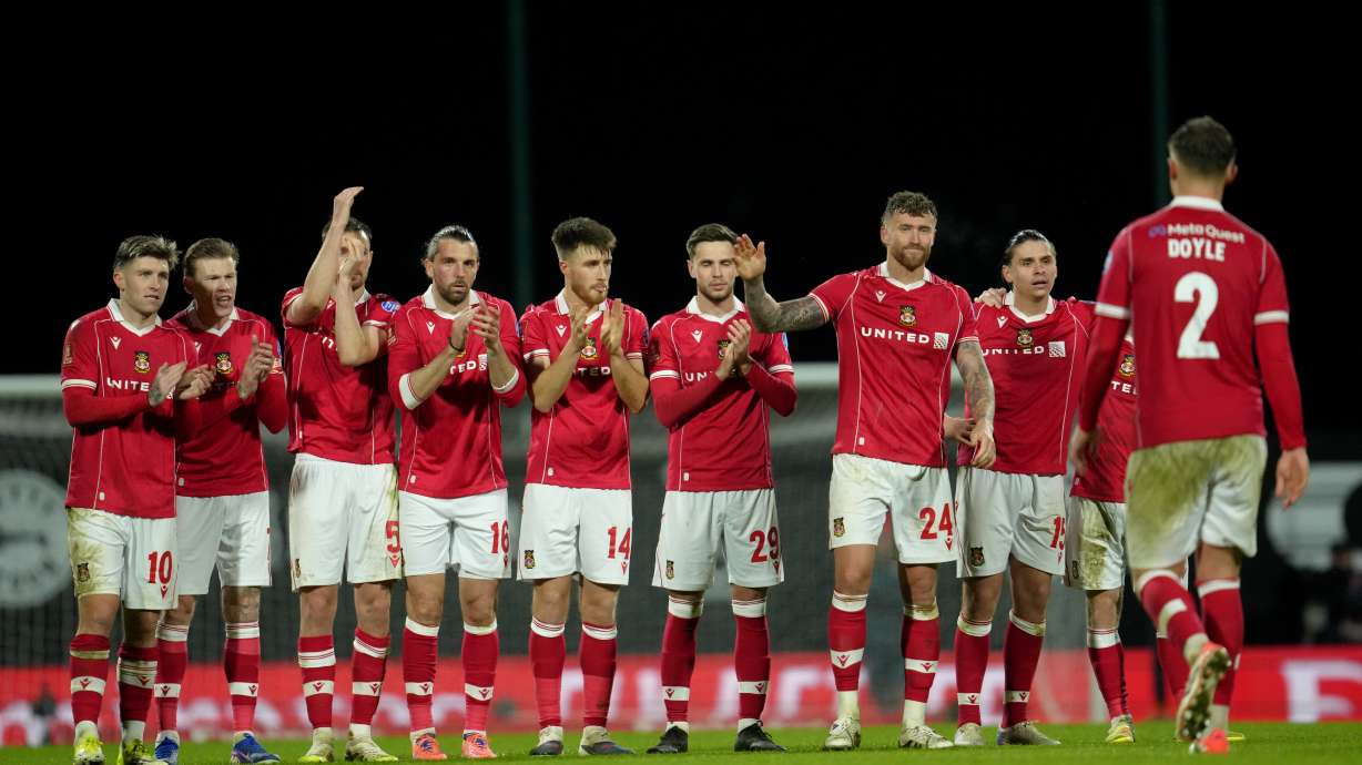 Wrexham players stand on the pitch during the penalty shootout at the end of the English FA Cup third round soccer match between Wrexham and Nottingham Forest in Wrexham, Wales, Friday, Jan. 9, 2026.