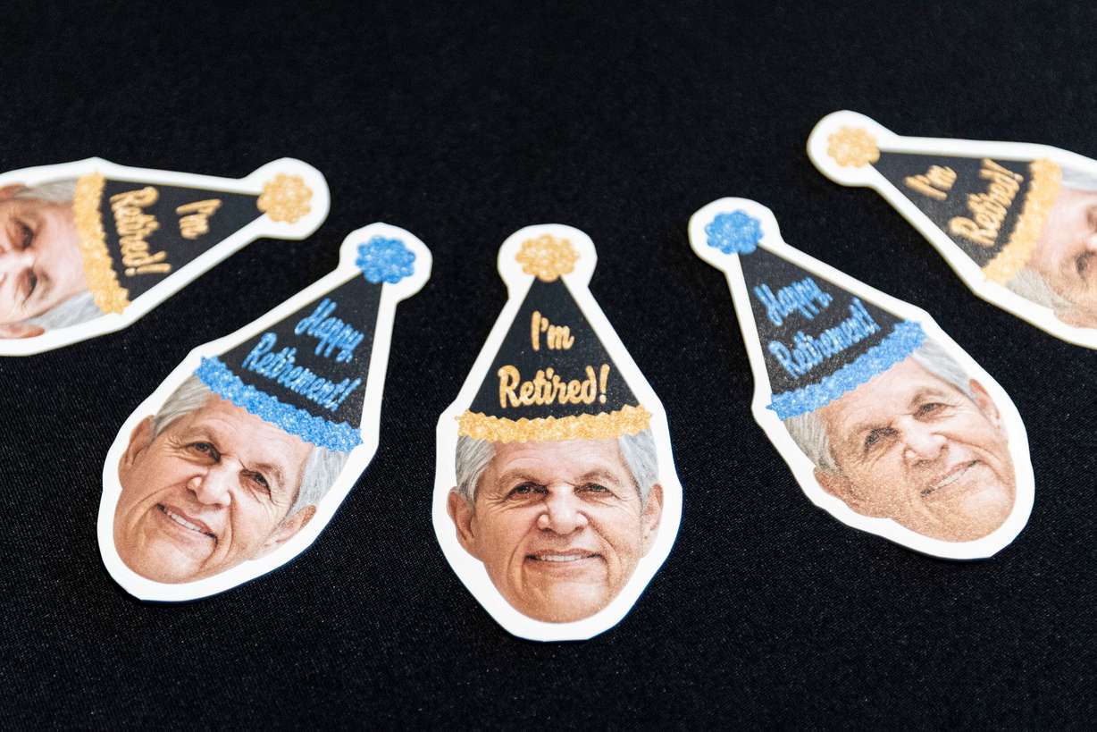 Stickers featuring the face of Rob Kallas, outgoing general manager for University Place, are displayed for attendees to take during a retirement party for Kallas, held at the Courtyard by Marriott Orem University Place hotel on Jan. 15.