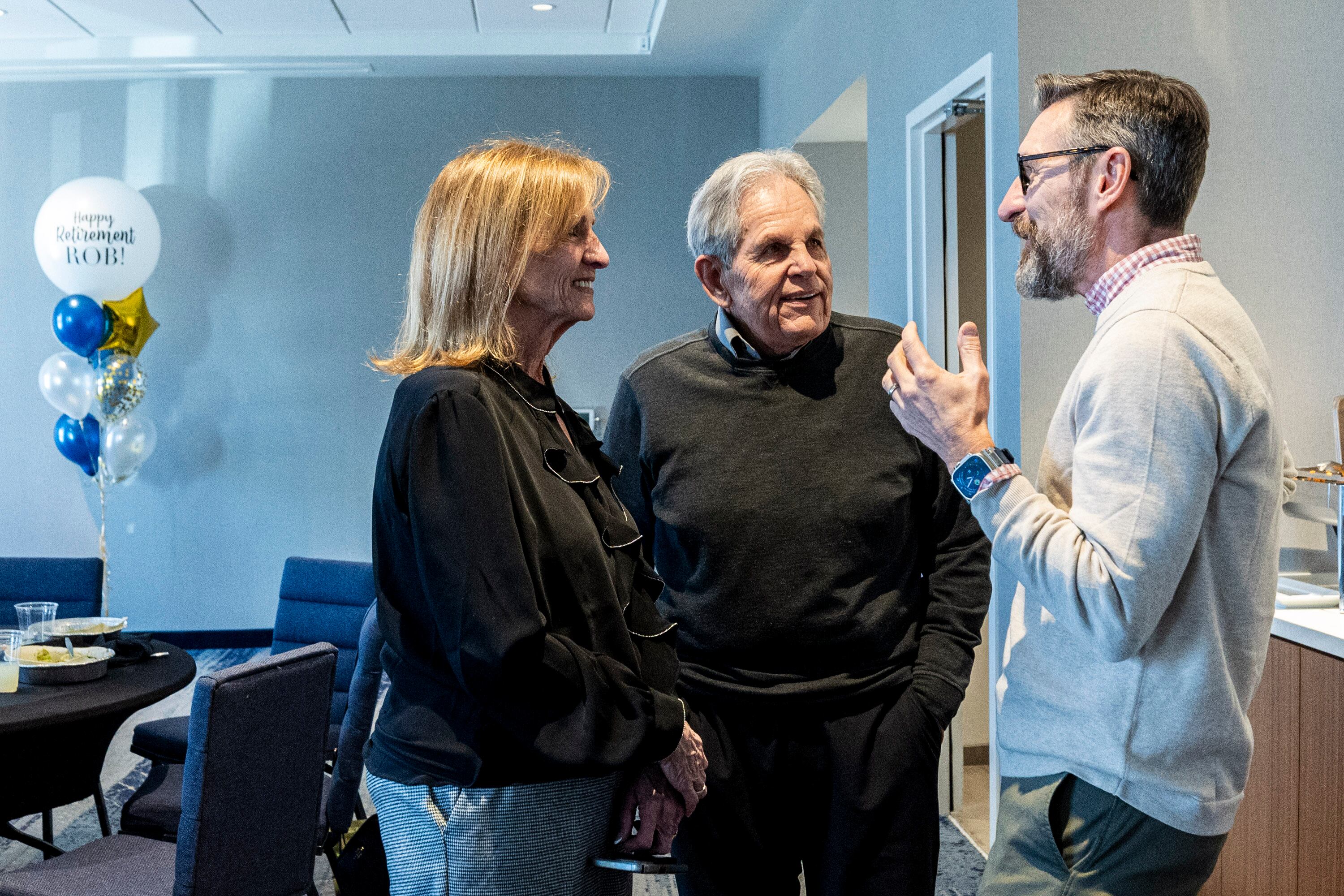 From right, Jason Wedlick, senior vice president of construction management at Woodbury Corporation, talks with Rob Kallas, outgoing general manager for University Place, and his wife, Janeal, during a retirement party for Kallas, held at the Courtyard by Marriott Orem University Place hotel on Jan. 15.