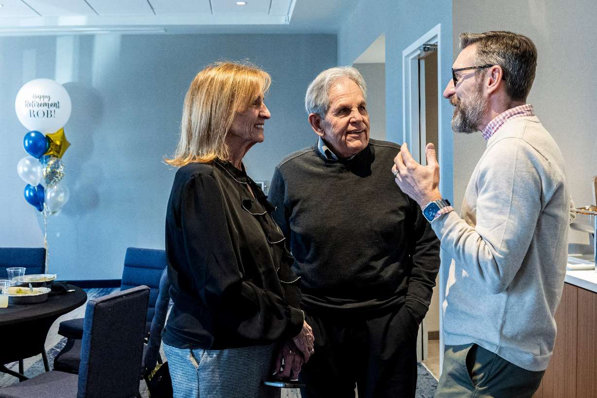 From right, Jason Wedlick, senior vice president of construction management at Woodbury Corporation, talks with Rob Kallas, outgoing general manager for University Place, and his wife, Janeal, during a retirement party for Kallas, held at the Courtyard by Marriott Orem University Place hotel on Jan. 15.
