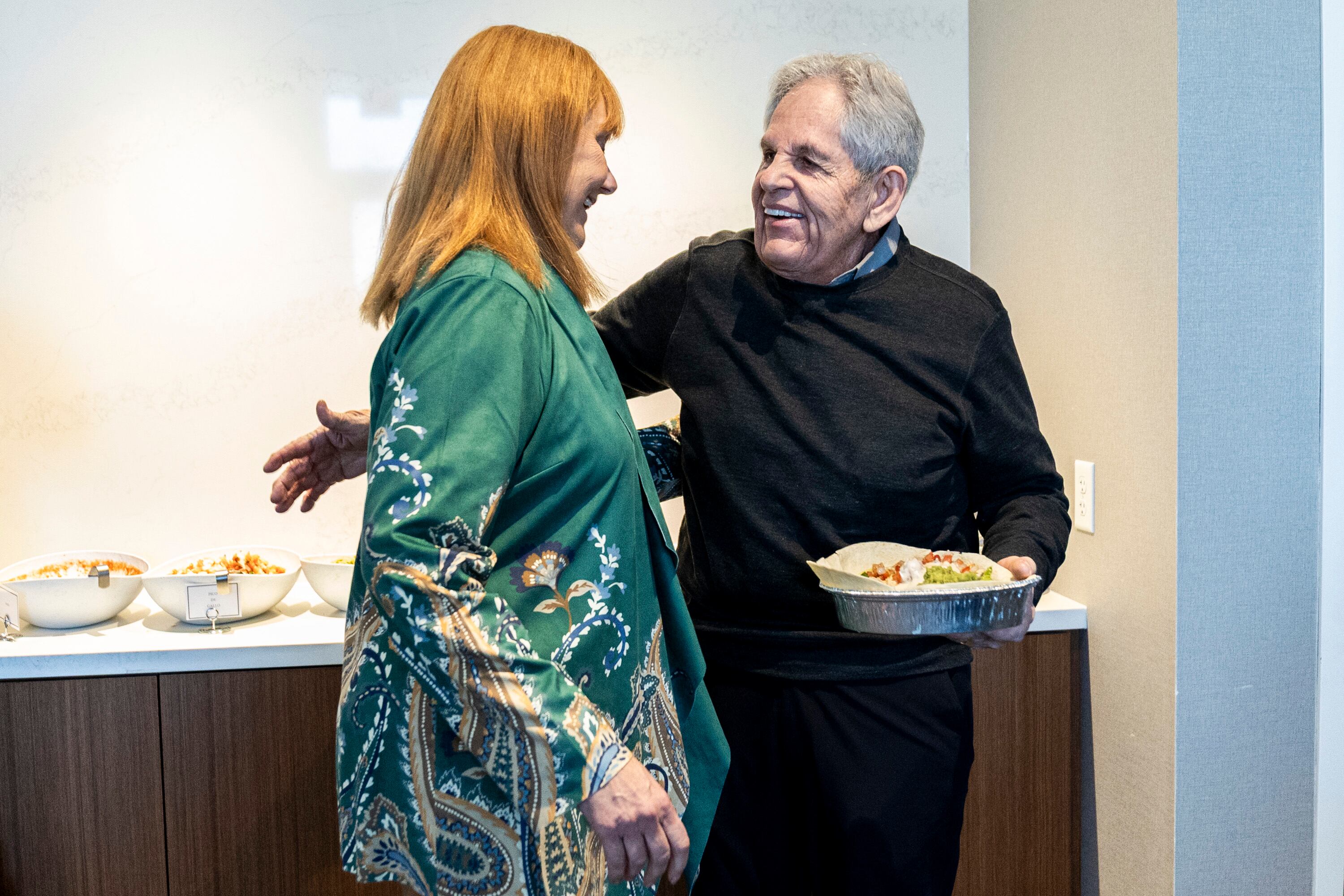 Rob Kallas, outgoing general manager for University Place, hugs Kathy Olson, director of development for Woodbury Corporation, during a retirement party for Kallas, held at the Courtyard by Marriott Orem University Place hotel on Jan. 15.