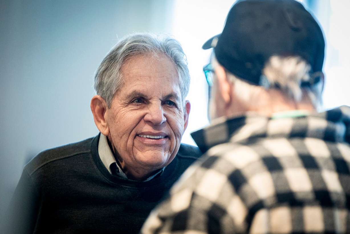 Rob Kallas, outgoing general manager for University Place, talks with Jeffrey K. Woodbury, senior vice president of development and acquisitions for Woodbury Corporation, during a retirement party for Kallas, held at the Courtyard by Marriott Orem University Place hotel on Jan. 15.