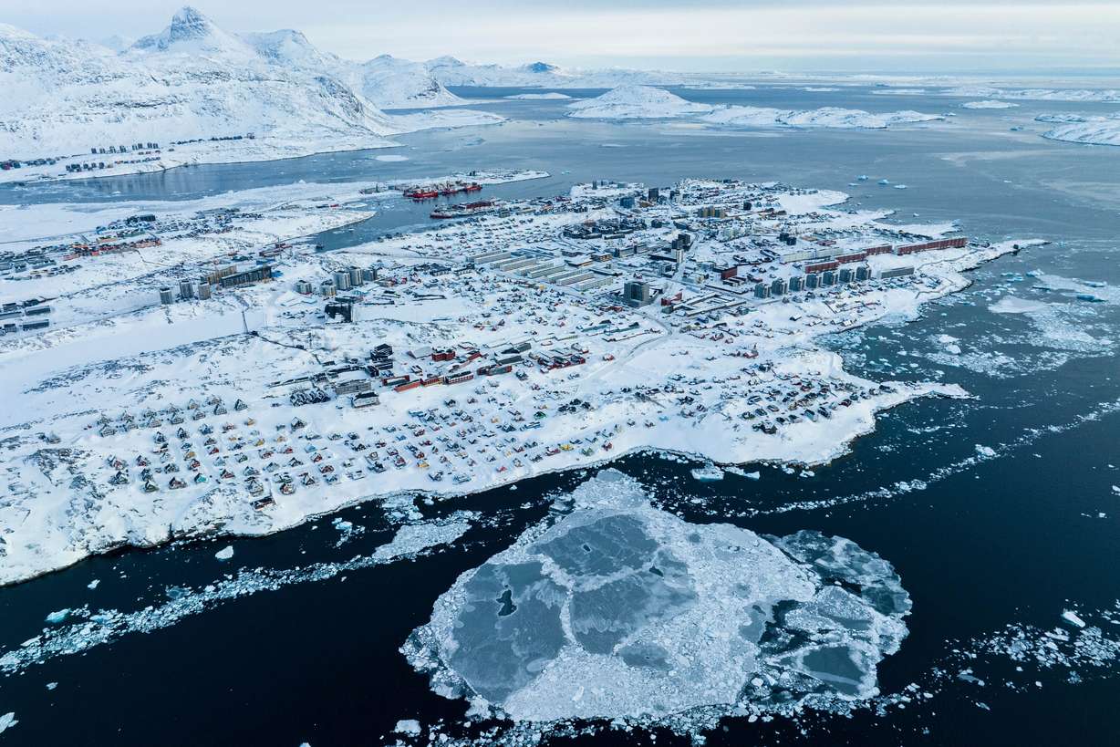 Houses covered by snow are seen on the coast of a sea inlet of Nuuk, Greenland, on March 7. Utah Rep. Blake Moore has called the threat of military action against Denmark over Greenland "absurd."