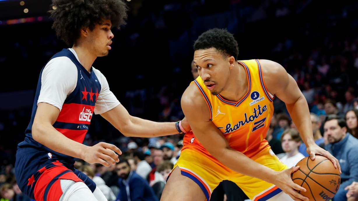Charlotte Hornets forward Grant Williams (2) looks to drive against Washington Wizards guard Kyshawn George during the first half of an NBA basketball game in Charlotte, N.C., Saturday, Jan. 24, 2026. .
